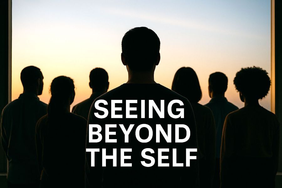 A group of people stand indoors facing a large window at sunset, their backs to the camera. The words “SEEING BEYOND THE SELF” are overlaid in bold, white capital letters across the image.